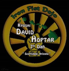 A yellow and green logo for the iron fist dojo.